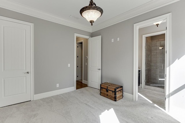 unfurnished bedroom featuring baseboards, carpet, and crown molding