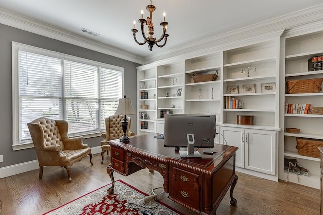 office space with baseboards, visible vents, a chandelier, wood finished floors, and crown molding