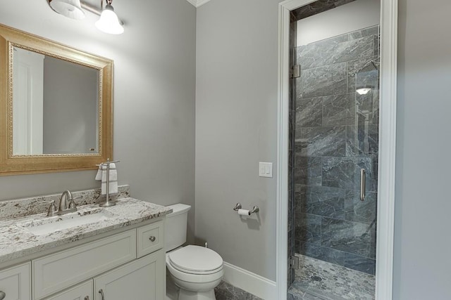 bathroom featuring baseboards, toilet, vanity, and a stall shower