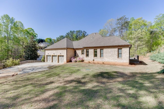 view of front of house featuring brick siding, an attached garage, driveway, and a front yard