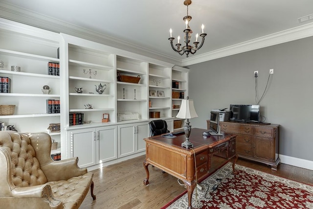 office featuring crown molding, wood finished floors, baseboards, a notable chandelier, and visible vents
