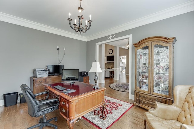 office featuring baseboards, wood finished floors, a chandelier, and crown molding