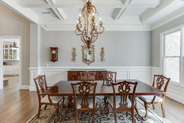 dining room with beam ceiling, an inviting chandelier, and coffered ceiling