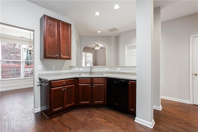 kitchen featuring ceiling fan with notable chandelier, dark hardwood / wood-style flooring, black dishwasher, and sink