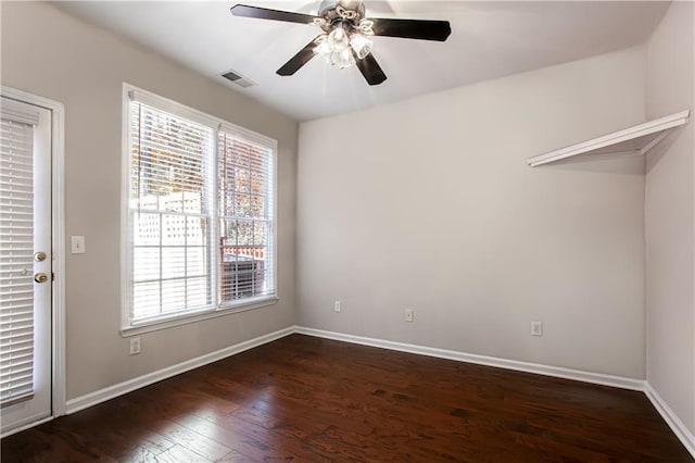 spare room with ceiling fan and dark hardwood / wood-style flooring