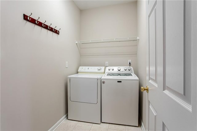 washroom featuring separate washer and dryer and light tile patterned flooring