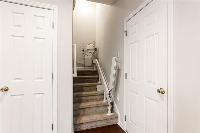 stairs featuring hardwood / wood-style floors