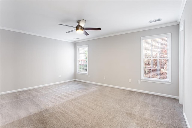 spare room with light colored carpet, ceiling fan, and ornamental molding