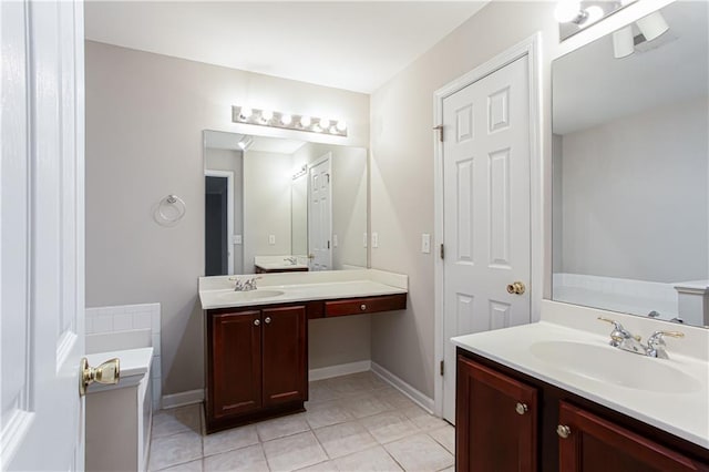 bathroom featuring a tub to relax in, tile patterned flooring, and vanity