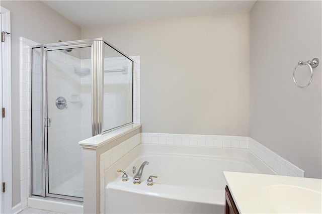 bathroom featuring vanity and independent shower and bath