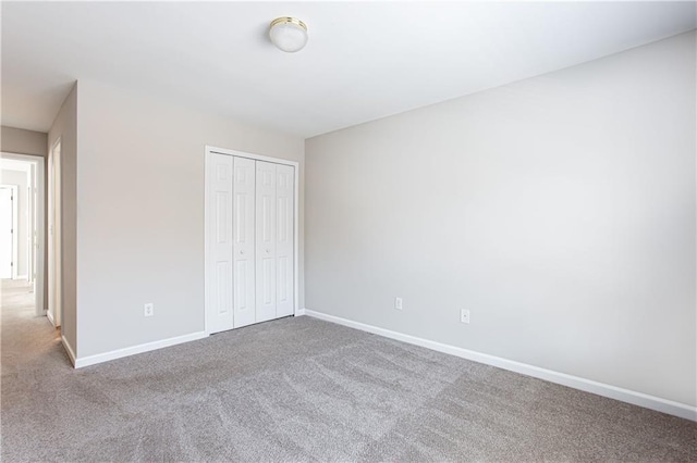 unfurnished bedroom with carpet flooring and a closet