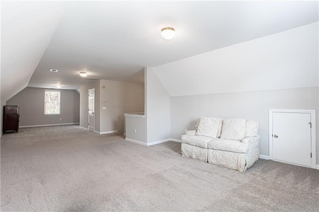 bonus room with light colored carpet and lofted ceiling