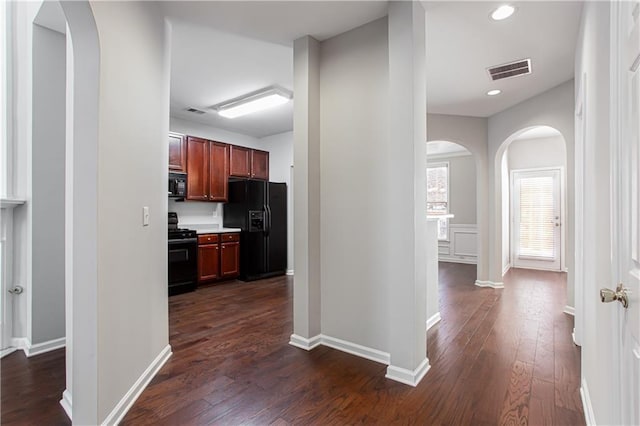 hallway with dark hardwood / wood-style flooring