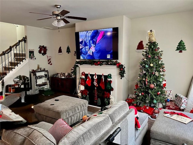 living room featuring hardwood / wood-style floors and ceiling fan