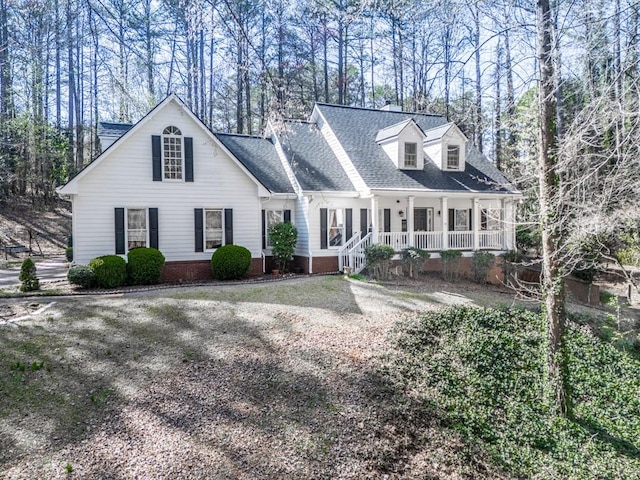 5090 Eubanks Rd, Woodstock, GA 30188 - cape cod-style house with a porch, view of wooded area, and roof with shingles