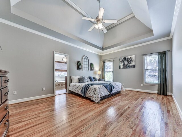 5090 Eubanks Rd, Woodstock, GA 30188 - bedroom featuring a tray ceiling, multiple windows, light wood-style floors, baseboards, and crown molding
