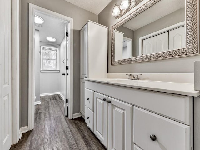 5090 Eubanks Rd, Woodstock, GA 30188 - bathroom featuring vanity, baseboards, wood finished floors, and a textured ceiling
