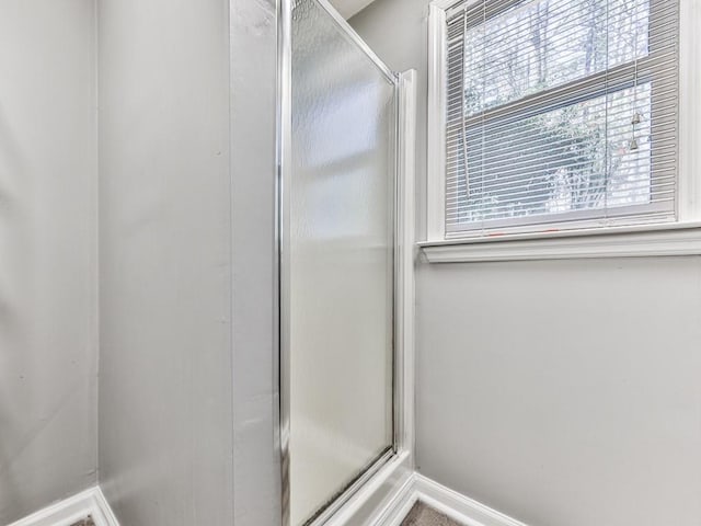5090 Eubanks Rd, Woodstock, GA 30188 - bathroom featuring baseboards and a stall shower