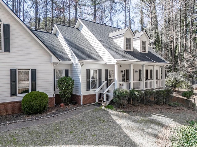 5090 Eubanks Rd, Woodstock, GA 30188 - cape cod-style house featuring covered porch and a shingled roof