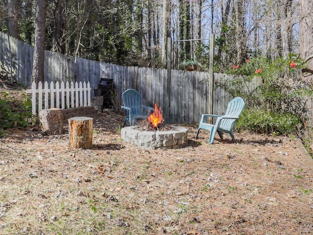 5090 Eubanks Rd, Woodstock, GA 30188 - fenced backyard with an outdoor fire pit