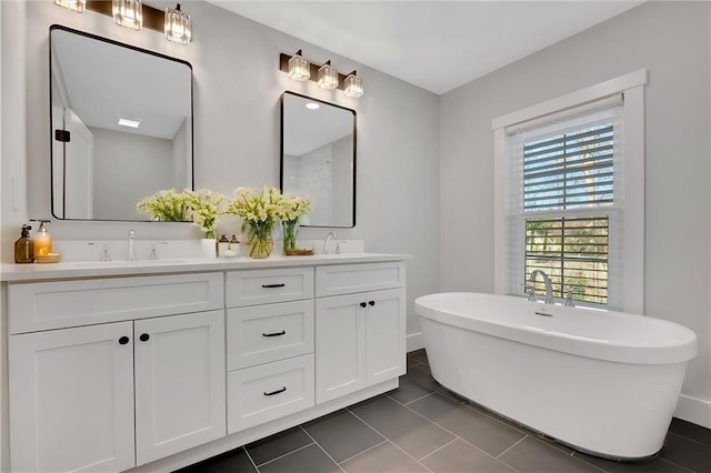 bathroom featuring a washtub, vanity, and tile patterned flooring