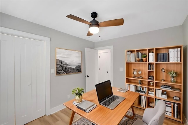 office area with ceiling fan and light hardwood / wood-style flooring