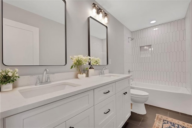 full bathroom featuring vanity, tiled shower / bath combo, and toilet