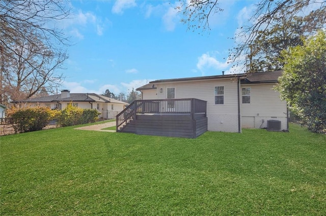 back of property with a yard, a deck, and central air condition unit