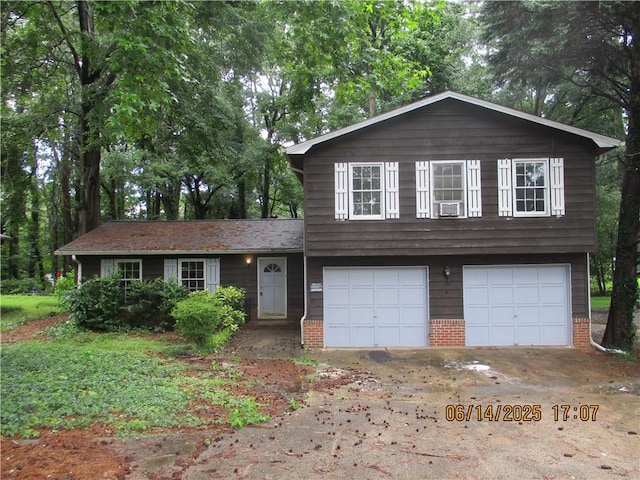 5382 Rockbridge Rd, Stone Mountain, GA 30088 - split level home with brick siding, an attached garage, driveway, and cooling unit