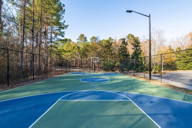 view of basketball court featuring community basketball court and fence