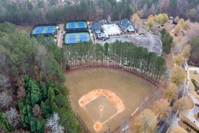 birds eye view of property with a forest view