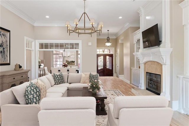 6191 Talmadge Run, Acworth, GA 30101 - living room with light wood-style flooring, a chandelier, a healthy amount of sunlight, and a fireplace