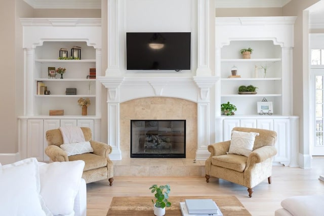 interior space featuring a fireplace, built in shelves, and light wood-type flooring