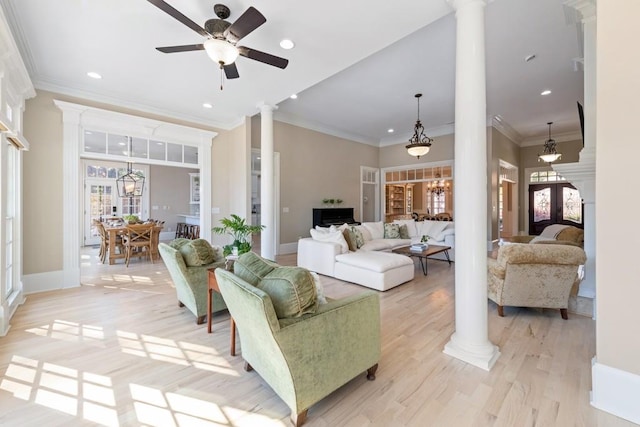 living room with ornamental molding, french doors, light hardwood / wood-style flooring, and decorative columns