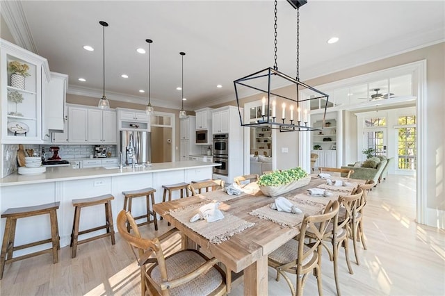 6191 Talmadge Run, Acworth, GA 30101 - dining room with light wood finished floors, french doors, ceiling fan with notable chandelier, recessed lighting, and ornamental molding