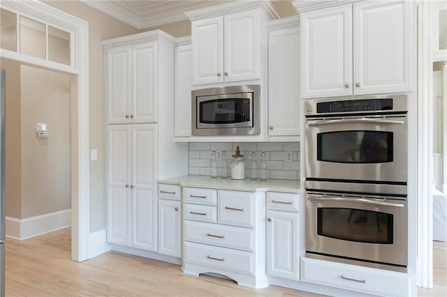 6191 Talmadge Run, Acworth, GA 30101 - kitchen featuring decorative backsplash, appliances with stainless steel finishes, light countertops, baseboards, and white cabinets