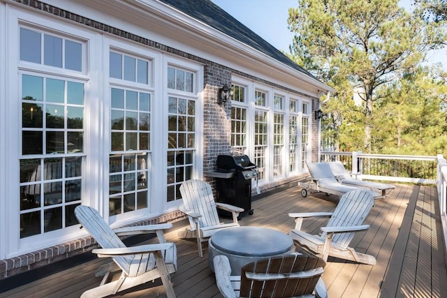 wooden terrace featuring a grill