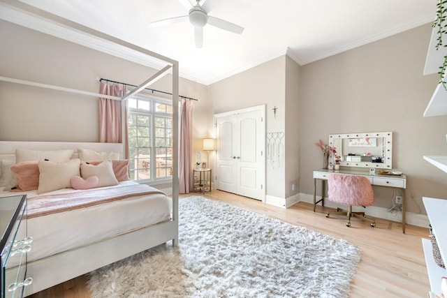 bedroom with hardwood / wood-style flooring, ceiling fan, and ornamental molding