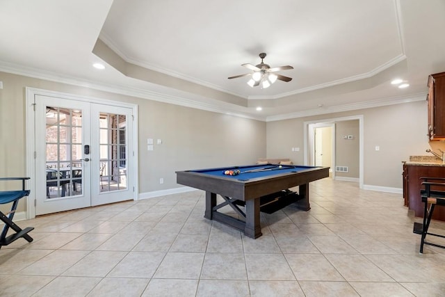 playroom with light tile patterned floors, french doors, a raised ceiling, and baseboards