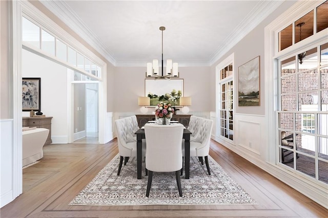 6191 Talmadge Run, Acworth, GA 30101 - dining space with an inviting chandelier, crown molding, a wainscoted wall, and a wealth of natural light