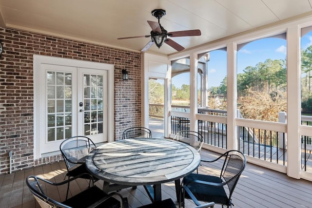 sunroom featuring french doors, a healthy amount of sunlight, and a ceiling fan