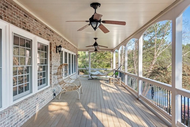 wooden deck with covered porch and ceiling fan