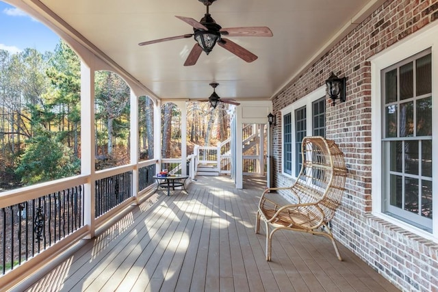 wooden deck with ceiling fan and a porch