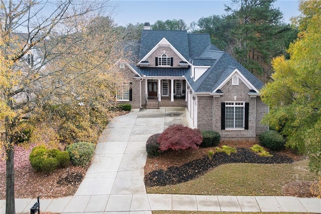 6191 Talmadge Run, Acworth, GA 30101 - view of front of home with brick siding, board and batten siding, roof with shingles, and a chimney