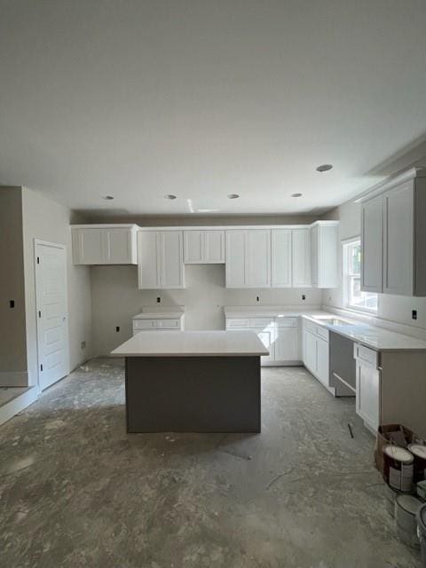 kitchen featuring a kitchen island and white cabinets