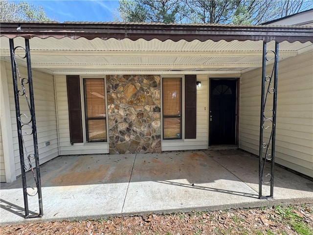 property entrance with a porch and stone siding