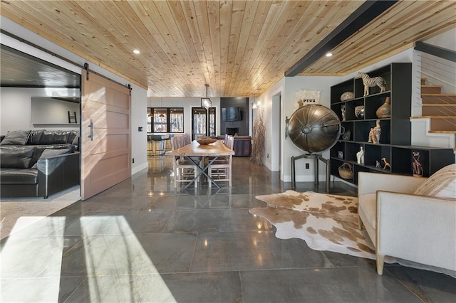 interior space featuring wood ceiling and a barn door