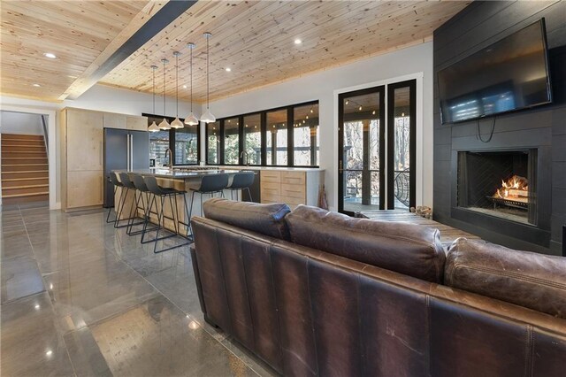 living room featuring wooden ceiling, a large fireplace, and beamed ceiling