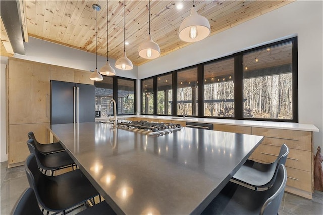 kitchen featuring wood ceiling, a kitchen breakfast bar, and hanging light fixtures