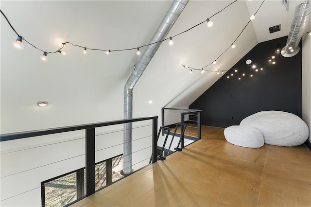 additional living space with concrete flooring and vaulted ceiling